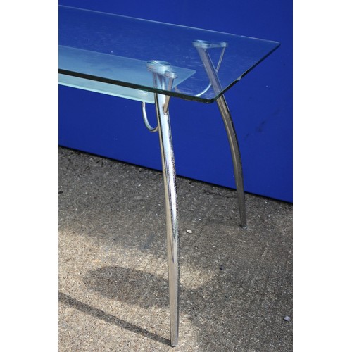 578 - A Glass And Chrome Desk / Table With Undershelf. 140cm x 80cm x 73cm Height.