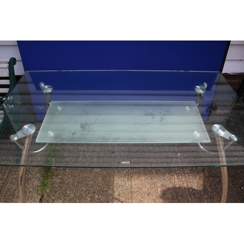 578 - A Glass And Chrome Desk / Table With Undershelf. 140cm x 80cm x 73cm Height.