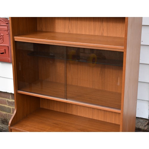 105 - A Tall Mid Century Schreiber Wall Unit Featuring Smoked Glass Doors And A Built In Light