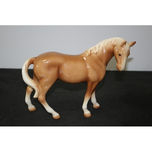 109 - A Beswick Light Brown/Tan Horse 21cm tall repair to one leg A/F