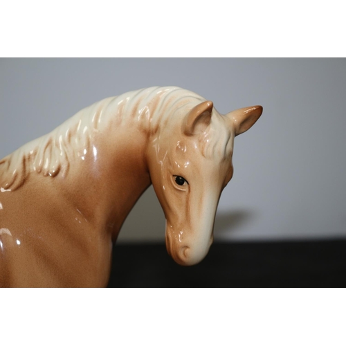 109 - A Beswick Light Brown/Tan Horse 21cm tall repair to one leg A/F