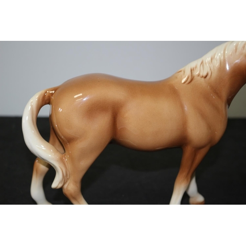 109 - A Beswick Light Brown/Tan Horse 21cm tall repair to one leg A/F