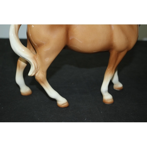 109 - A Beswick Light Brown/Tan Horse 21cm tall repair to one leg A/F