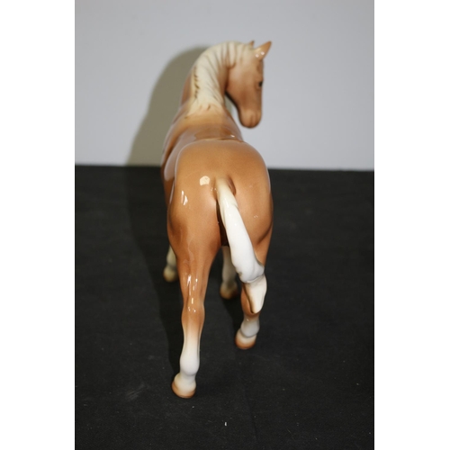 109 - A Beswick Light Brown/Tan Horse 21cm tall repair to one leg A/F