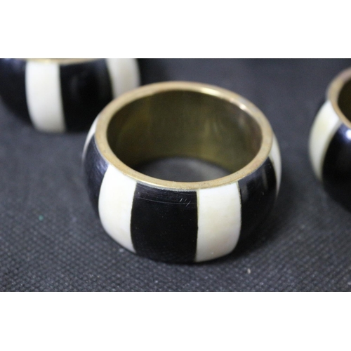 306 - Set of 8 Napkin Rings Brass and Believed to be Ebony and Ivory Inlay