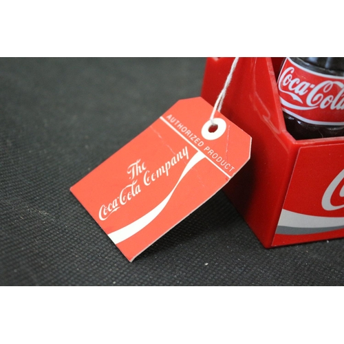 31 - From The Coca Cola Company A Set of 6 Miniature Coca Cola Bottles in a Carrier 9cm tall