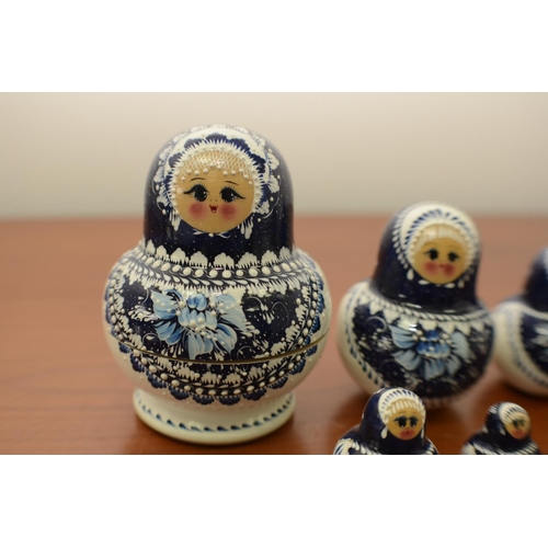 825 - Blue and White Russian Doll with 9 Dolls