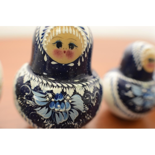 825 - Blue and White Russian Doll with 9 Dolls