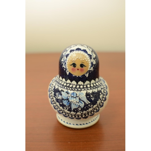 825 - Blue and White Russian Doll with 9 Dolls