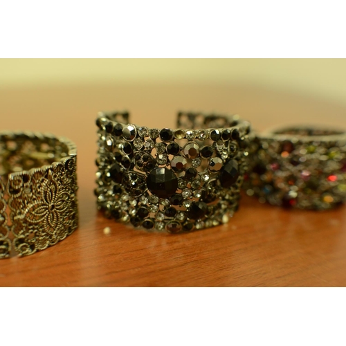 418 - A Selection of Ornate Costume Bangles with Pastel Stones