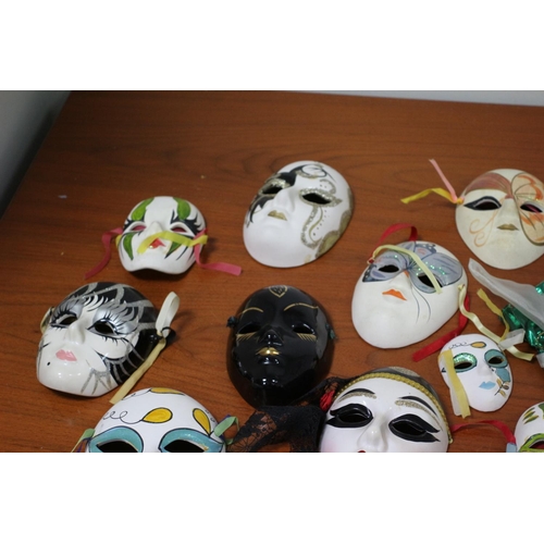 555 - A large collection of ceramic and porcelain Venetian style Masks