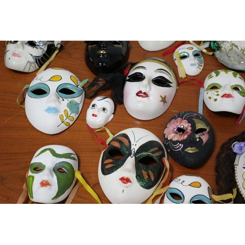 555 - A large collection of ceramic and porcelain Venetian style Masks