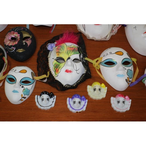 555 - A large collection of ceramic and porcelain Venetian style Masks