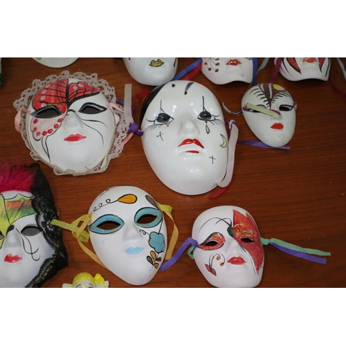 555 - A large collection of ceramic and porcelain Venetian style Masks