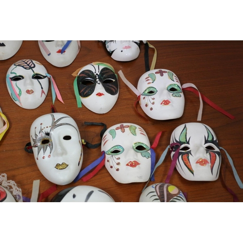 555 - A large collection of ceramic and porcelain Venetian style Masks