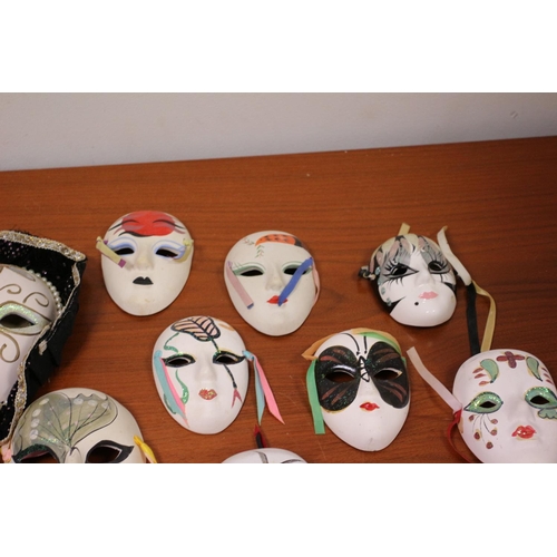 555 - A large collection of ceramic and porcelain Venetian style Masks