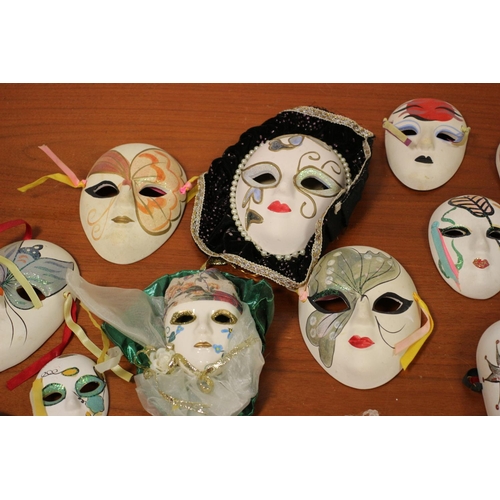 555 - A large collection of ceramic and porcelain Venetian style Masks