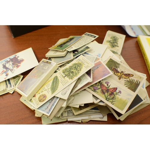 329 - A Box of Stamps, Post Cards aged and 2 Trade Card Catalogues