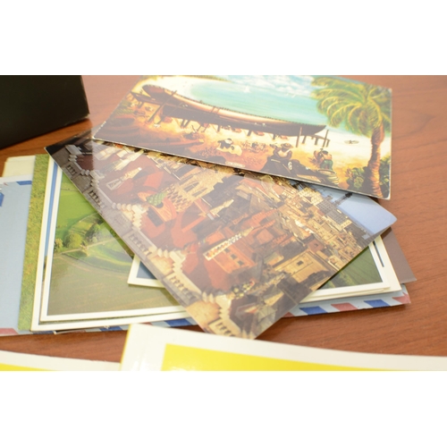 329 - A Box of Stamps, Post Cards aged and 2 Trade Card Catalogues