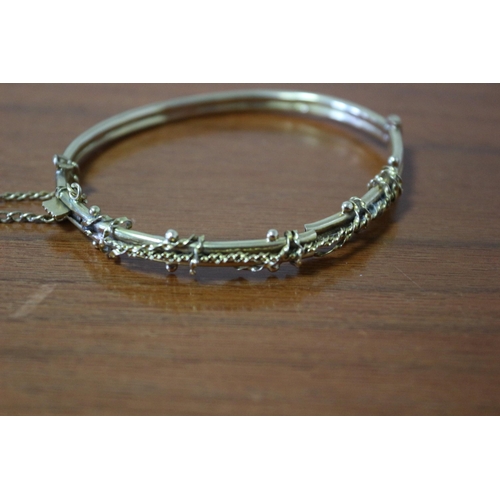 259 - Presented as 9k Gold Hollow Bangle with Safety Chain