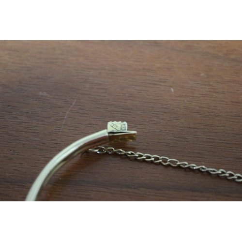 259 - Presented as 9k Gold Hollow Bangle with Safety Chain