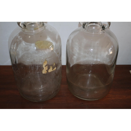 103 - 2 x Glass Demijohn Jugs with Twin Finger Handles