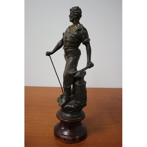 105 - Spelter/ Metal Blacksmith on Wooden Base 39cm