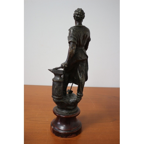 105 - Spelter/ Metal Blacksmith on Wooden Base 39cm