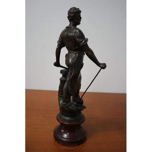 105 - Spelter/ Metal Blacksmith on Wooden Base 39cm