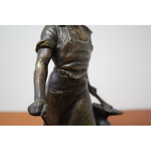 105 - Spelter/ Metal Blacksmith on Wooden Base 39cm