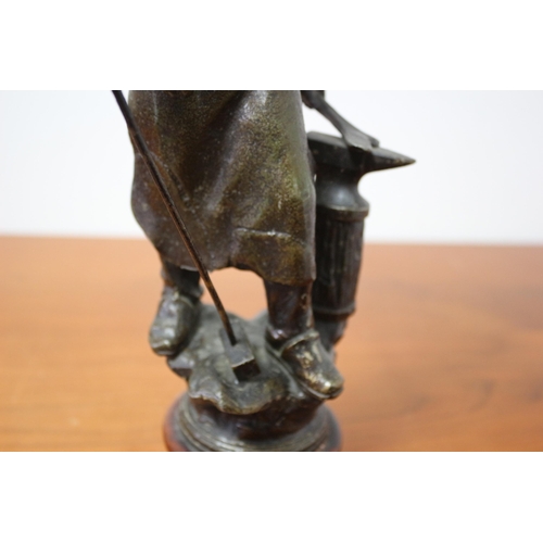 105 - Spelter/ Metal Blacksmith on Wooden Base 39cm