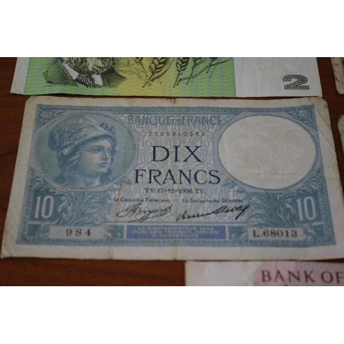 41 - 10 Shilling Note, 2 x £1 notes plus Foreign notes of age