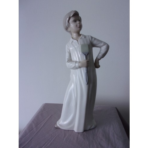 396 - Neo Figurine of young Boy holding what looks to be like a fly swot  marked on bottom 29cm tall