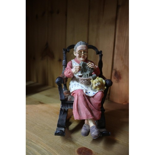 128 - Couple in rocking chairs pottery