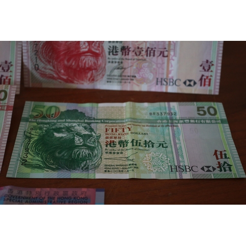 305 - 3 x 100$ Hong Kong Dollar Notes plus a 50$ Dollar and a 10$ Note