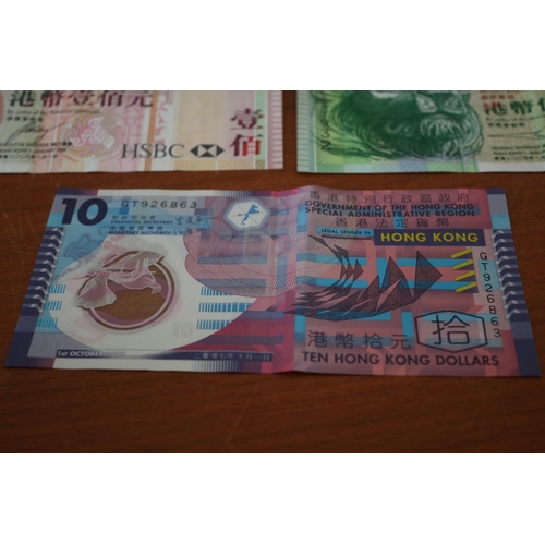 305 - 3 x 100$ Hong Kong Dollar Notes plus a 50$ Dollar and a 10$ Note