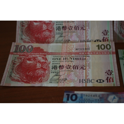 305 - 3 x 100$ Hong Kong Dollar Notes plus a 50$ Dollar and a 10$ Note