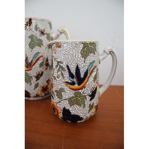 390 - Believed to be a Vintage Keeling & Co Pair of Highly Decorative Jugs with Bird and Floral Design