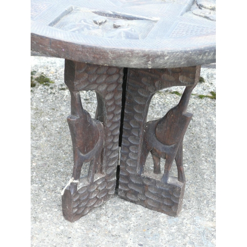 89 - Carved table with elephants, 53cm diameter x 42cm height