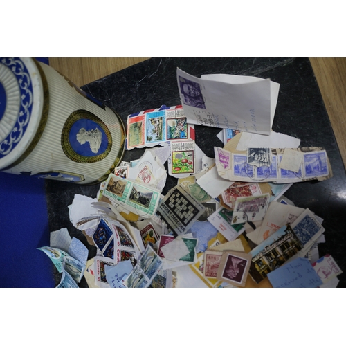 18 - TIN CONTAINING BUNDLE OF STAMPS