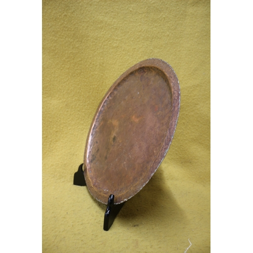 22 - Arts and Crafts hand beaten brass plate, 36cm diameter