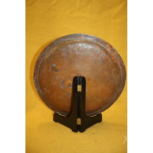 22 - Arts and Crafts hand beaten brass plate, 36cm diameter