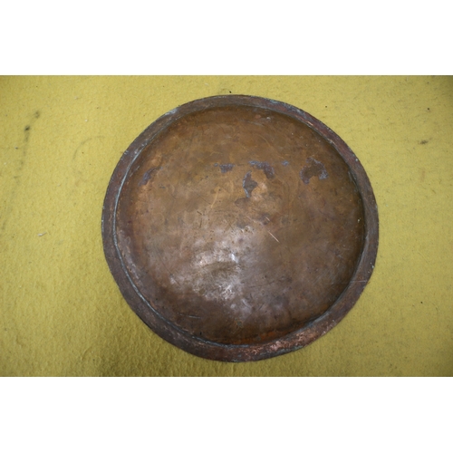 22 - Arts and Crafts hand beaten brass plate, 36cm diameter