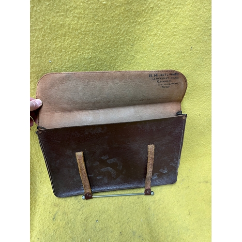 547 - Vintage leather satchel with hook over securing metal bar