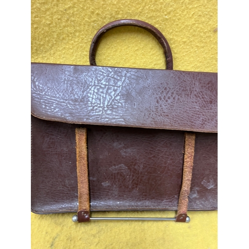 547 - Vintage leather satchel with hook over securing metal bar