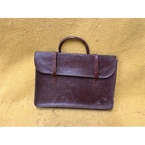 547 - Vintage leather satchel with hook over securing metal bar