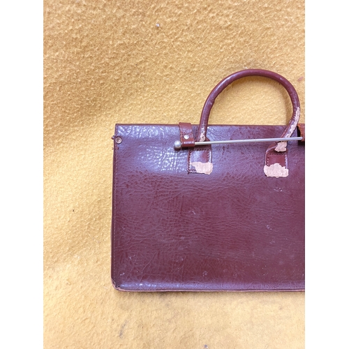 547 - Vintage leather satchel with hook over securing metal bar