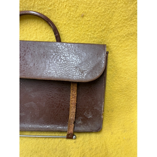 547 - Vintage leather satchel with hook over securing metal bar