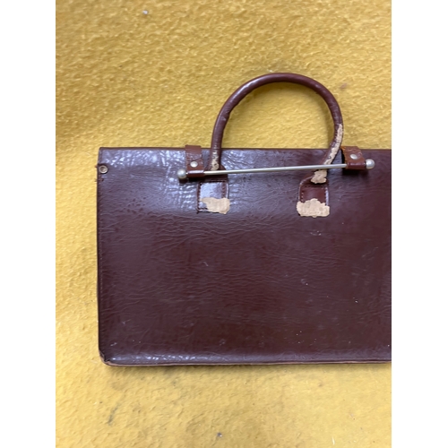 547 - Vintage leather satchel with hook over securing metal bar