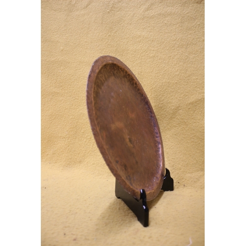 174 - Arts and Crafts hand beaten copper plate, 36cm diameter